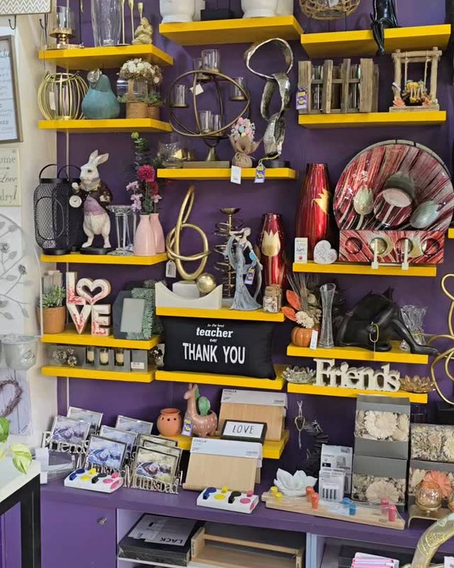 Inside Blings et'al: decor on mustard shelving against the purple wall